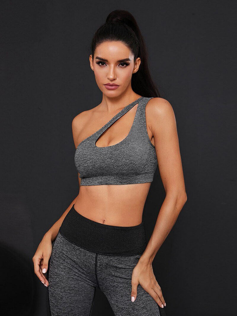 Stylish women's one-shoulder sports bra in gray, perfect for fitness activities, offering comfort and quick-dry performance.
